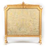 A LATE 19TH CENTURY GILT GESSO FIRE SCREEN with dot and dart cornice and leaf moulded surround,