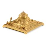 AN EARLY 20TH CENTURY CAST BRASS INKSTAND with leaf work decoration, fitted pen rest 18.5cm square.