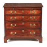 A GEORGE II FIGURED MAHOGANY CHEST OF DRAWERS with inverted corners to the top above a brushing