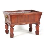 AN UNUSUAL REGENCY WINE COOLER of tapering rectangular form with a panelled front and lion's mask