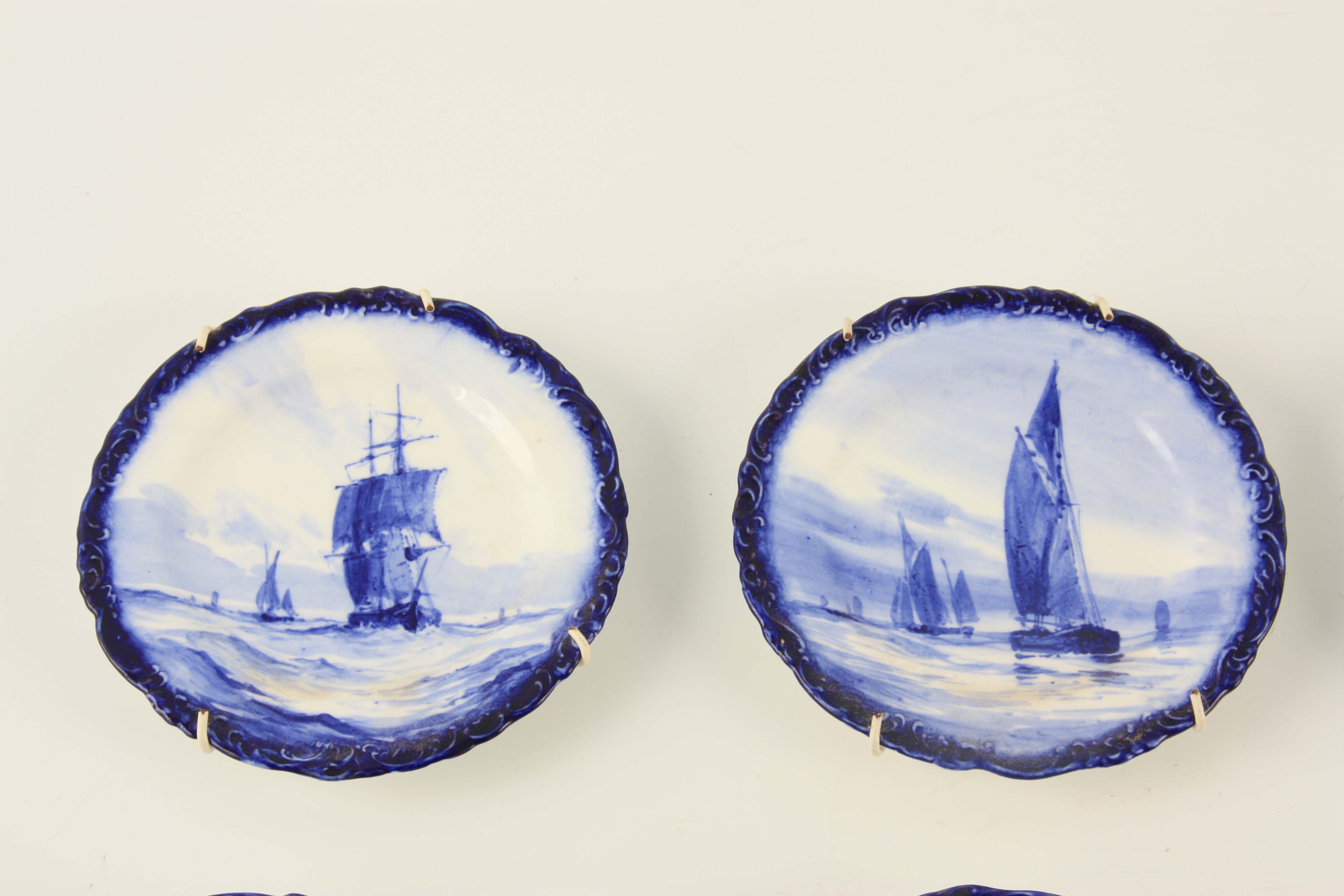 A SET OF EIGHT ROYAL CROWN DERBY SMALL HANGING PLATES painted with differing sailboats on a blue - Image 3 of 9