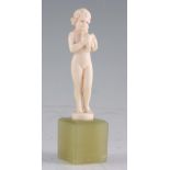ATT. TO FERDINAND PREISS. AN ART DECO CARVED IVORY FIGURE modelled as a naked girl holding a dove,