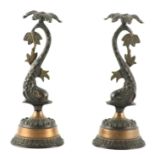 A PAIR OF 20TH CENTURY REGENCY STYLE BRONZE LAMPS MODELLED AS DOLPHINS having leaf work sconces;