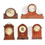 A SELECTION OF FIVE EARLY 20TH CENTURY MANTEL CLOCKS in oak, walnut, and mahogany cases all with