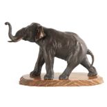 A LARGE JAPANESE MEIJI PERIOD PATINATED BRONZE SCULPTURE modelled as an elephant standing on a
