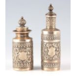 TWO EASTERN SILVER METAL BOTTLES AND STOPPERS with embossed leaf work decoration 12cm and 9.5cm