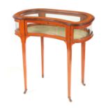 AN EDWARDIAN INLAID SATINWOOD KIDNEY SHAPED BIJOUTERIE TABLE with hinged top having a bevelled