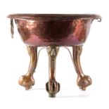 A 17TH CENTURY COPPER AND BRASS ITALIAN BRAZIER having a circular moulded top standing on mask