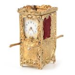 AN EARLY 20TH CENTURY SWISS SILVER MINIATURE SEDAN CARRIAGE CLOCK the floral embossed case enclosing