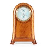 AN UNUSUAL EDWARDIAN SATINWOOD MANTEL ALARM CLOCK the arched case with concave moulded edge and