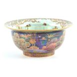 A FINE WEDGWOOD FAIRYLAND LUSTRE FOOTED BOWL WITH EVERTED RIM AFTER DESIGNS BY DAISY MAKEIG JONES
