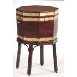 A GEORGE III MAHOGANY HEXAGONAL SHAPED WINE COOLER with brass banding and axe drop handles, the