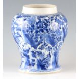 A CHINESE KANGHI PERIOD BLUE AND WHITE JAR of baluster form decorated with floral panels, the