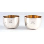 A PAIR OF GEORGE II SILVER AND SILVER GILT TUMBLER CUPS with engraved monograms to the bodies