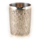 A STYLISH ELIZABETH II SILVER BEAKER BY GERALD BENNEY, LONDON, 1969 of cylindrical form with bark