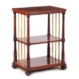 A LATE REGENCY FIGURED ROSEWOOD WHATNOT IN THE MANNER OF GILLOWS with three shelves joined by ring
