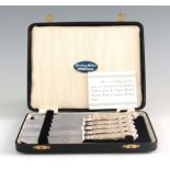 A SET OF SIX MID 20TH CENTURY QUEENS PATTERN SILVER HANDLED CAKE KNIVES in a Moroccan fitted case,