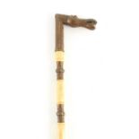A 19TH CENTURY CHINESE CAST BRASS AND MARINE IVORY WALKING STICK of sectional form with turned ivory