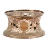 A 19TH CENTURY LARGE SILVER PLATE ON COPPER DISH RING with ribbed edges, the concave body embossed