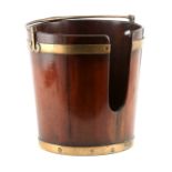 A GEORGE III BRASS BOUND MAHOGANY PLATE BUCKET with folding handle fitted scroll-shaped brackets, of