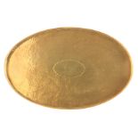 A NEWLYN SCHOOL 1920's BRASS OVAL HAND BEATEN TRAY with side handle slots and pierced gallery, the