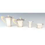 A GEORGE VI FOUR PIECE SILVER TEA AND COFFEE SERVICE OF ART DECO DESIGN the plain tapering bodies