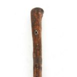 AN EARLY 18TH CENTURY SWORD STICK with full bark shaft and iron mounts, revealing a 26cm fullered