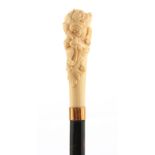 A LATE 19TH CENTURY IVORY CARVED HEAD WALKING STICK DEPICTING THE GREEN MAN with gold metal collar