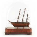 A SMALL 19TH CENTURY SHIPS MODEL UNDER GLASS DOME modelled as a three-masted clipper with rigging
