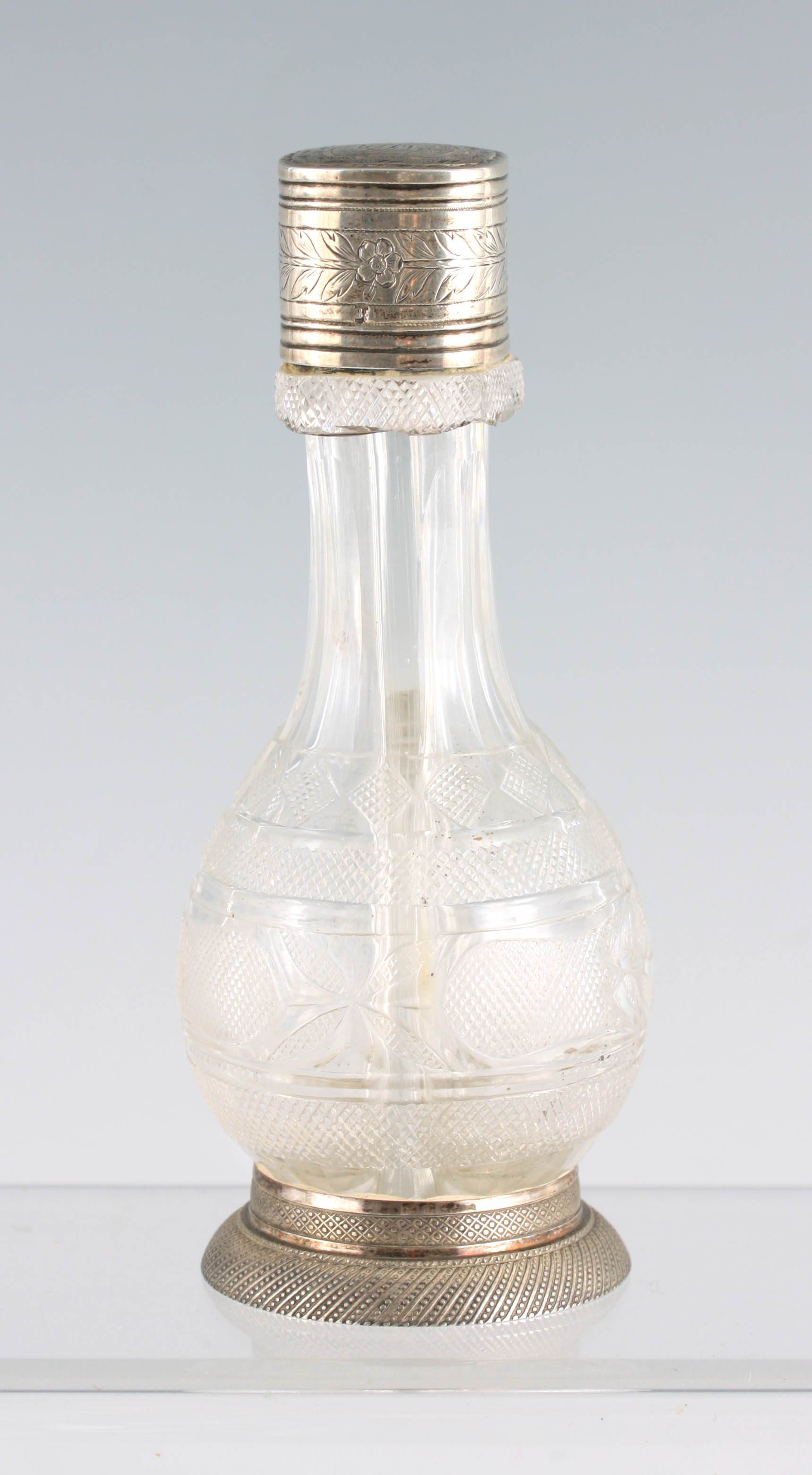 A 19TH CENTURY CONTINENTAL SILVER MOUNTED FOUR-WAY DRESSING TABLE BOTTLE DECANTER with finely cut