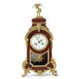 A LATE 19TH CENTURY FRENCH TORTOISESHELL AND ORMOLU MOUNTED MANTEL CLOCK the arched case having