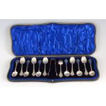 A CASED SET OF TWELVE EDWARD VII SILVER TREFID STYLE TEASPOONS AND SUGAR TONGS hallmarked London1906