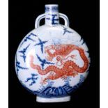 AN UNDERGLAZE-BLUE AND COPPER-RED DECORATED ‘DRAGON’ MOONFLASK each side decorated in copper red (