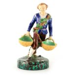 A 19TH CENTURY MINTON MAJOLICA FIGURE finely modelled as a young man carrying baskets coloured in