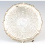 A VICTORIAN PROFUSELY ENGRAVED SCALLOP-EDGE SILVER SALVER with bead edge border and profusely