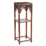 A TALL 19TH CENTURY CHINESE HARDWOOD JARDINIERE STAND/WHATNOT with moulded square uprights, shaped
