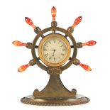 A 19TH CENTURY GILT BRASS SHIP'S WHEEL CLOCK WITH AGATE HANDLES and retailers plaque for "