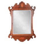 AN EARLY 19TH CENTURY FIGURED WALNUT HANGING MIRROR with cushion moulded frame and bevelled mirror