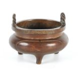 A 19TH CENTURY CHINESE PATINATED BRONZE CENSER of squat bulbous form with rope twist handle and