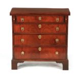 AN EARLY 18TH CENTURY WALNUT BACHELORS CHEST with solid timber fold over top supported by loppers