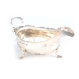 A GEORGE III SAUCEBOAT with shaped rim and hoof feet 14cm wide 7.5cm high London by Nathaniel