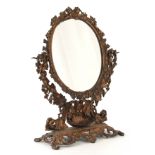 A 19TH CENTURY COALBROOKDALE STYLE GILT HIGHLIGHTED BRONZED CAST IRON DRESSING TABLE MIRROR of