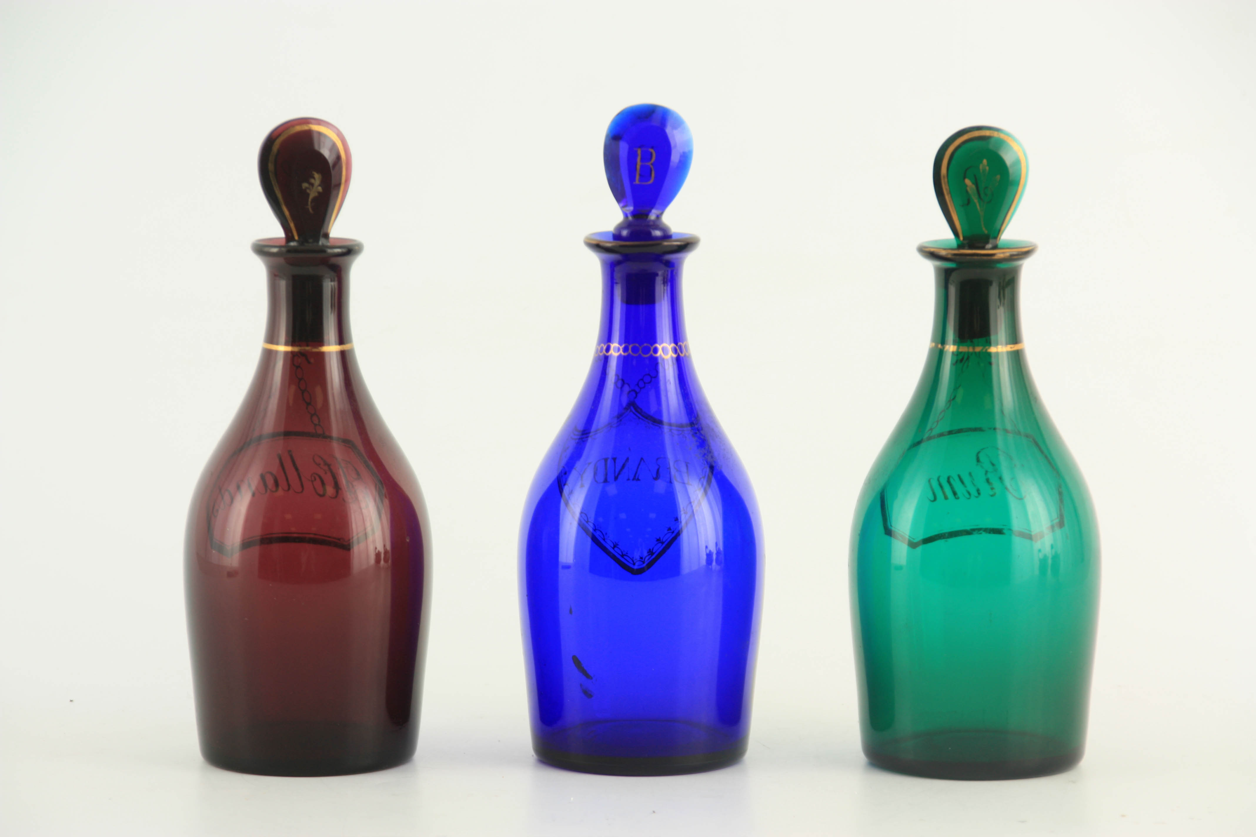 A MATCHED SET OF THREE LATE GEORGIAN COLOURED SPIRIT DECANTERS with gilt work labels for Rum, - Image 10 of 10