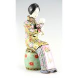 A LATE 19TH CENTURY CHINESE PORCELAIN FIGURE OF A MOTHER AND CHILD SEATED ON A CERAMIC SEAT in