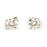 A PAIR OF LADIES SOLITAIRE DIAMOND EARRINGS the brilliant-cut stones on18ct white gold mounts,