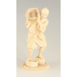 A 19TH CENTURY JAPANESE CARVED IVORY FIGURE of a standing male with a rice basket and container on