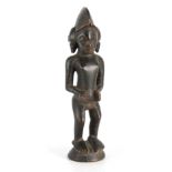 AN 19TH CENTURY AFRICAN CARVED TRIBAL STANDING FIGURE 30.5cm high