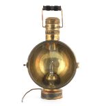 A LATE 19TH CENTURY BRASS CARRYING LAMP with folding handle and hinged glazed door fronting a