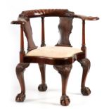 AN UNUSUAL 19TH CENTURY MAHOGANY CORNER CHAIR with leaf carved top rail and dolphin arms supported