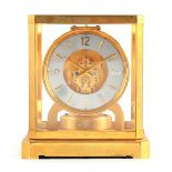 AN EARLY 1950's LECOULTRE ATMOS II CLOCK the glazed gilt case with canted corners and larger base